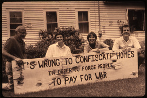 Supporters of war tax resisters Randy Kehler and Betsy Corner kneeling with sign reading 'It's wrong to confiscate in order to force people to pay for war'