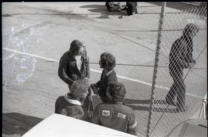 Hollywood Speedway Rock Festival: Free Spirit Press crew talking by chain link fence