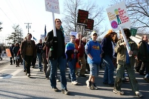 Marchers in the streets with anti-war signs: rally and march against the Iraq War