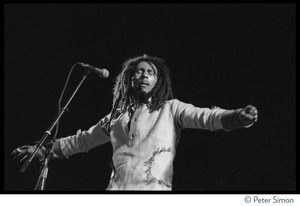 Bob Marley in concert, arms spread out