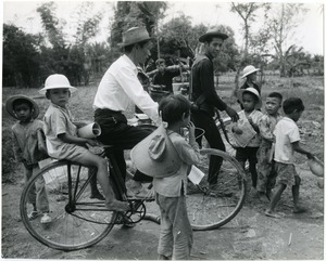 Man on bicycle with children