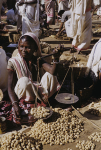 Woman weighing dried bread in the market in Ranchi