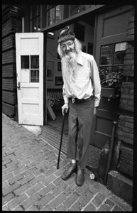 Prescott Townsend standing outside a building on Beacon Hill, with cane
