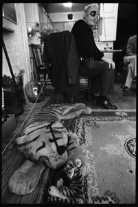 W. Eugene Smith, seated at a desk: view over stuffed toy tigers
