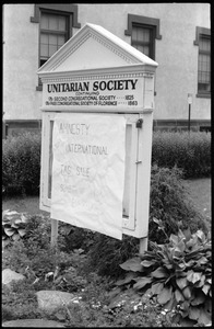 Sign for the Unitarian Society of Florence and Northampton, Main Street, with notice of tag sale for the benefit of Amnesty International