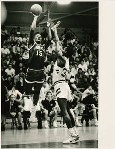 SC Basketball player, Ramses Kelly, taking a shot over a defender