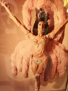 A Photograph of Marlow Monique Dickson Posing in a Feathered and Beaded Outfit
