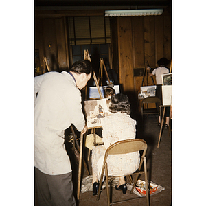 Adults painting in an art class