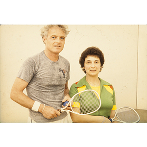 Man and woman holding racquetball racquets