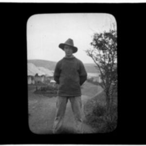 Portrait of man in hat in front of camp