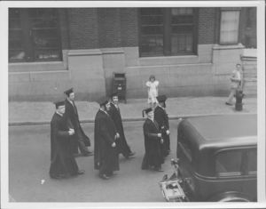 Group of graduates walking at the Suffolk University's first Baccalaureate exercise, 6/13/1937
