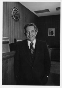 Suffolk University President David J. Sargent (1989-2010) standing in the moot court room