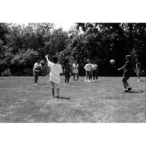 Inquilinos Boricuas en Acción employees playing soccer in a field during a staff outing.