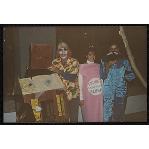 Four adults in Halloween costumes pose for shot