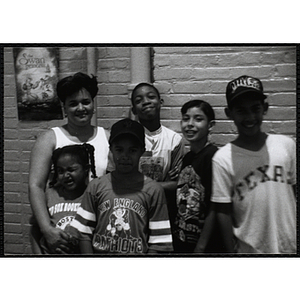 A woman poses for a group shot with children