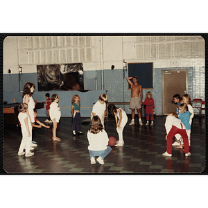 A group of girls play a ball game in a hall