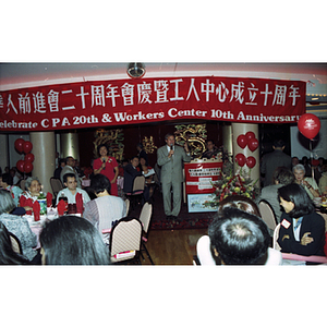 Politician Scott Harshbarger and woman address group at restaurant for Chinese Progressive Association's 20th Anniversary Celebration
