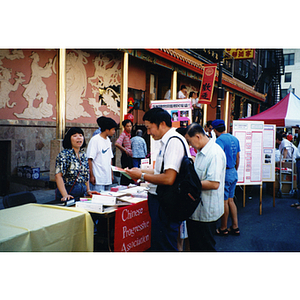 People at the Chinese Progressive Association's table at the August Moon Festival