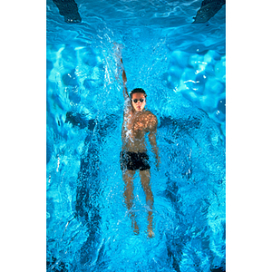 Male swimmer practicing backstroke