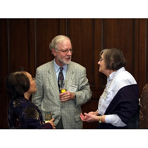 Dr. William Hancock talking with Beverly Brenner, right, at a gala dinner for John Hatsopoulos