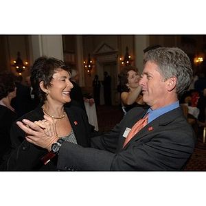 Two guests dance at the Alumni Ball