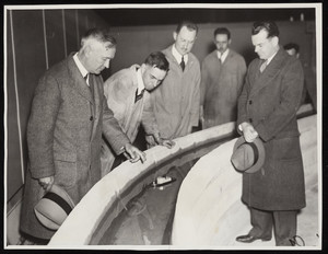 Army engineers study the model of the Cape Cod Canal