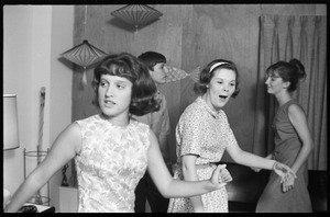 Teenage long hair: teenage girls at a dance party held in a room decorated in mid-century modern style