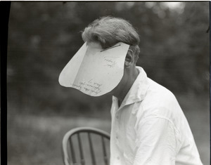 George Allan England wearing an oversized visor reading "George Allan England / Sophomore year / French 17 / Notes / Synopsis"