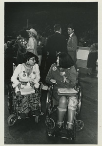 Two delegates in wheelchairs
