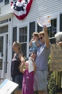 Family protesting outside the Chatham town office building, holding a sign reading 'Families belong together': taken at the 'Families Belong Together' protest against the Trump administration’s immigration policies