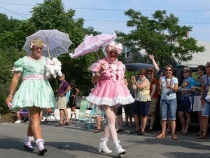Parade marchers in pastel gingham dresses and parasols : Provincetown Carnival parade