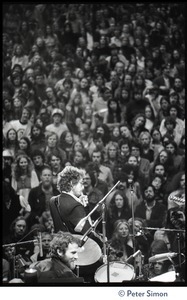 Bob Dylan performing on stage at the Boston Garden with The Band, Levon Helm on drums in the foreground