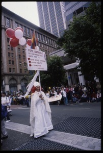 Man dressed as Pope Unpious I marching in San Francisco Pride Parade, carrying sign: 'Pope Pious I of San Francisco... says yes to safe sex/ condoms, human rights, alternative lifestyles'