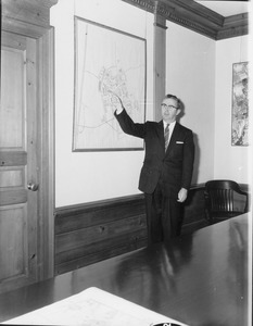 Jean Paul Mather pointing at wall map