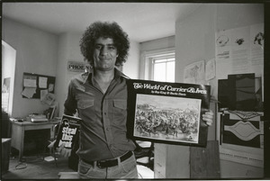 Abbie Hoffman holding copies of Steal This Book and The World of Currier and Ives