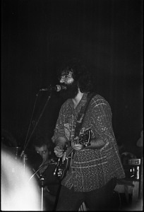 Grateful Dead performing at the Music Hall: Jerry Garcia onstage, playing guitar and singing