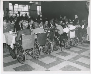 Clients in wheelchairs eating Thanksgiving dinner