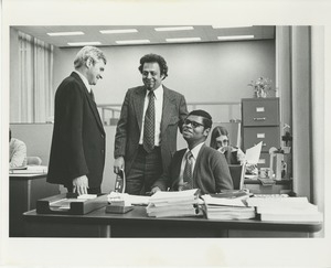 Man in a wheelchair seated at a desk