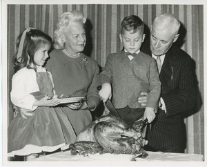 Hermann G. Place with Mrs. H. Lawrence Bogert, Jr. and two young clients at Thanksgiving celebration