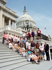 Congressman John W. Olver with group of visitors, posed on the steps of the United States Capitol building