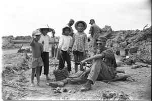 Soldiers of the 9th Infantry Division filling sandbags with assistance of Vietnamese children; Dong Tam.