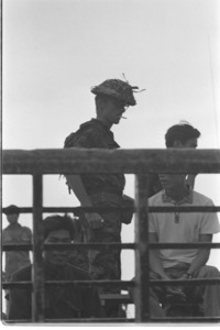 U.S. advisor wearing a Vietcong helmet captured on the battle field.