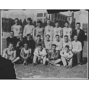 Group portrait of track team with coaches outside