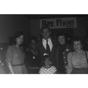 Mayor Raymond Flynn stands in a group of women with Carmen Pola at a Wigglesworth Street rally