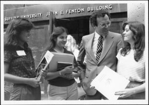 Suffolk University President Daniel H. Perlman (1980-1989) talks with students outside the Fenton Building (32 Derne Street) during orientation