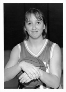 Suffolk University women's basketball player Kate Norton, posed holding basketball, circa 1996