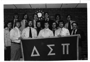Members of Suffolk University's Delta Sigma Pi Fraternity chapter holding a banner, 1970