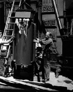 Employees lifting transformer