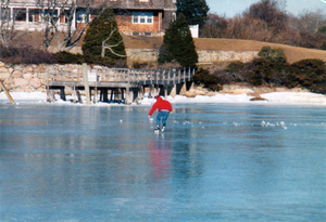 Bob McCullough skating on the smooth sea ice of Outer Quissett Harbor