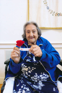 Anna Duarte holding an American Legion red poppy